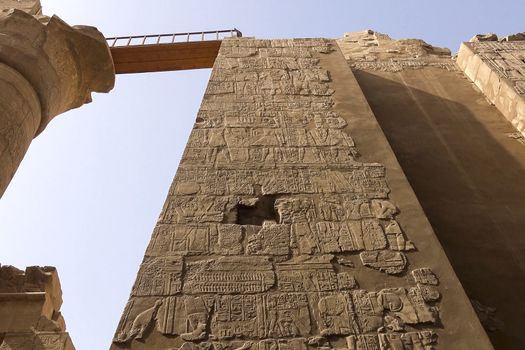 Egyptian hieroglyphs and drawings on the walls and columns. Egyptian language, The life of ancient gods and people in hieroglyphics and drawings