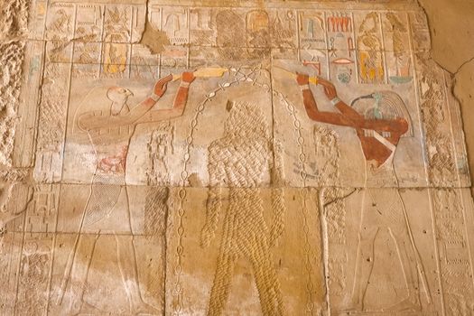 Egyptian hieroglyphs and drawings on the walls and columns. Egyptian language, The life of ancient gods and people in hieroglyphics and drawings