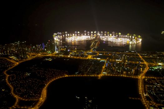 Festive firework in Dubai. Beautiful colorful holiday fireworks in the evening sky with majestic clouds, long exposure