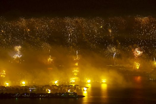 Festive firework in Dubai. Beautiful colorful holiday fireworks in the evening sky with majestic clouds, long exposure