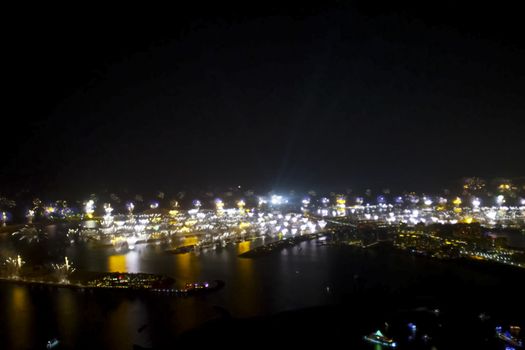 Festive firework in Dubai. Beautiful colorful holiday fireworks in the evening sky with majestic clouds, long exposure