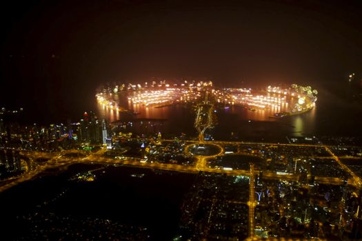 Festive firework in Dubai. Beautiful colorful holiday fireworks in the evening sky with majestic clouds, long exposure