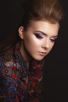Studio Portrait of a beautiful young model girl with glamorous evening makeup