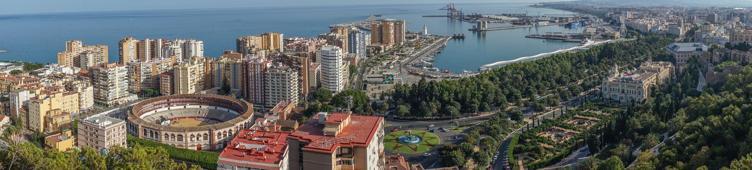Panorama City skyline and harbour, sea port, bullring of Malaga overlooking the sea ocean in Malaga, Spain, Europe  on a summer day with blue sky
