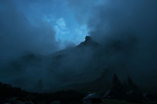Heavy clouds or haze over a distant mountain peak.