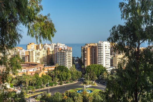 City skyline of Malaga overlooking the sea ocean in Malaga, Spain, Europe on a bright summer day with blue skies with trees