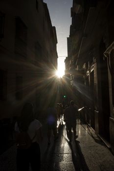 The golden sun sets across the streets of Malaga, Spain, Europe on a summer day