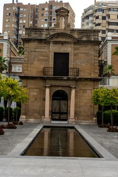 Small cozy building along the beach in Malaga, Spain, Europe with a small pond