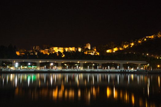 View of Alcazaba from harbour, Malaga, spain, Europe at night