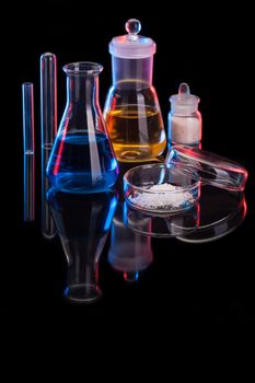 The Chemistry Lab background. Various glass chemistry lab equipment on black with copy space