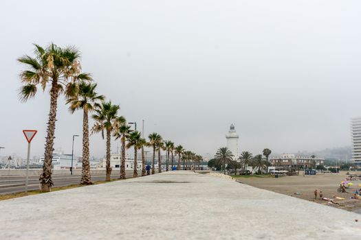 The lighthouse at Malagueta beach in Malaga, Spain, Europe on a cloudy morning