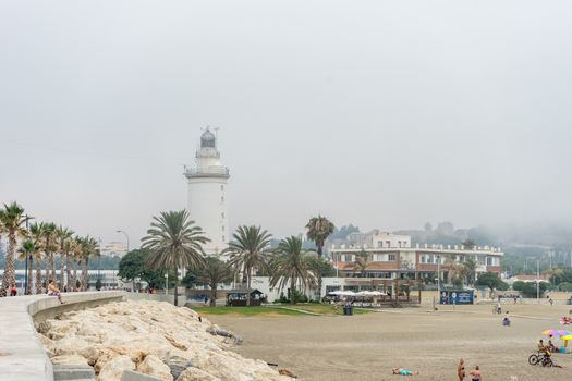 The lighthouse at Malagueta beach in Malaga, Spain, Europe on a cloudy morning