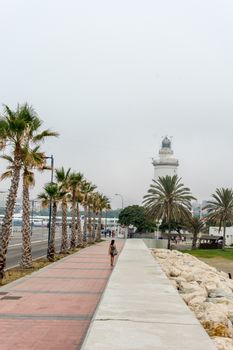 The lighthouse at Malagueta beach in Malaga, Spain, Europe on a cloudy morning