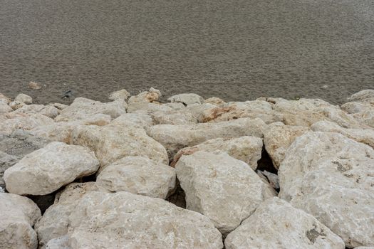 Stone along the Malagueta beach in Malaga, Spain, Europe on a foggy morning
