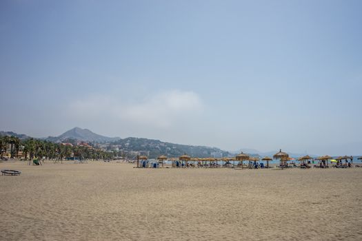 A hill overlooking the sandy Malagueta beach at Malaga, Spain, Europe on a cloudy morning