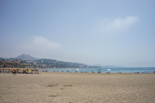 A hill overlooking the sandy Malagueta beach at Malaga, Spain, Europe on a cloudy morning