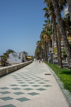 Pathway along the malagueta beach at Malaga, Spain, Europe on a bright summer day wih clear blue skies