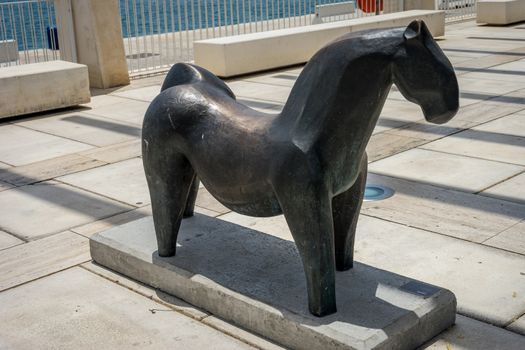 Sculpture of a stone horse at the malagueta beach at Malaga, Spain, Europe on a bright summer day