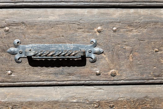 Close up of rustic old door in Spoleto, Italy.