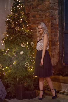 stylish happy woman decorating christmas tree.seasonal greetings concept