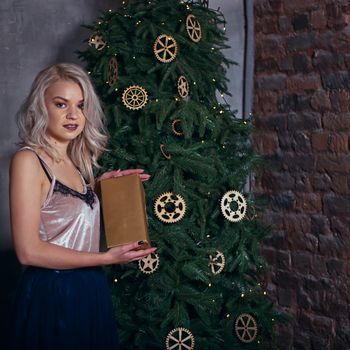 stylish happy woman decorating christmas tree.seasonal greetings concept