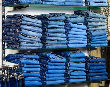 Closeup shot of stack of folded jeans in the fashion store