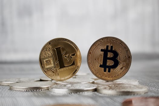 Digital currency physical gold litecoin and bitcoin coins on the silver money.