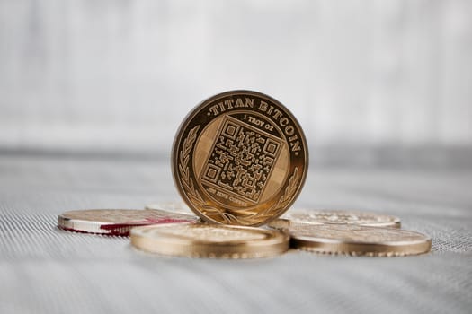 Digital currency physical gold titan bitcoin coin on the money. Business concept.