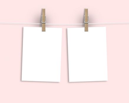 Paper cards hanging on a clothesline with clothespins on light background