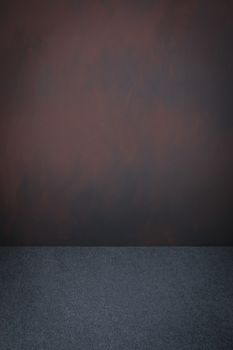 Grey carpet and dark brown grey grungy painted wall with vignette, use for background