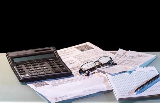 still life showing someone is leading household finances using a calculator