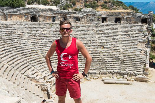 Young man at theatre in Myra ancient city of Antalya in Turkey.