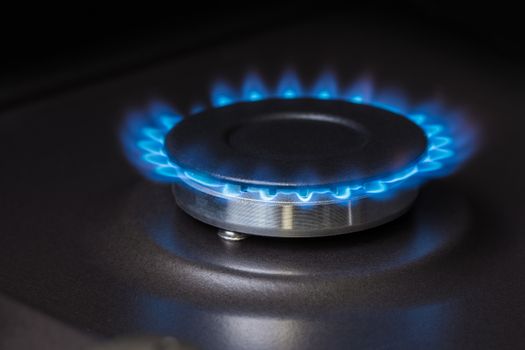 black kitchen gas stove burning burner close-up