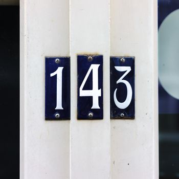 Enameled house number one hundred and forty three (143)