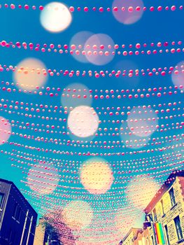 Festive street in gay neighborhood decorated with pink balls, with bokeh light effect. Annual summer installation in gay village on Ste-Catherine street, Montreal (Quebec, Canada).