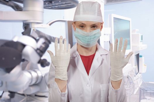 Young woman - doctor in front of medical equipment in modern hospital.