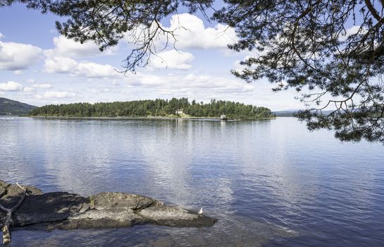 Utoya island with green forest and a house in norway near Oslo where Breivik shot a lot of students in 2011