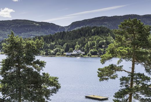 Utoya island with green forest and a house in norway near Oslo where Breivik shot a lot of students in 2011