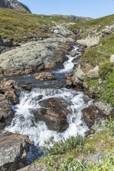 small waterfall on the bitihorn track in norway