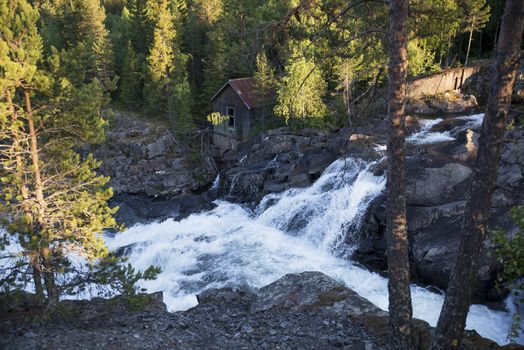 old wooden house with waterfall in norway near Leira