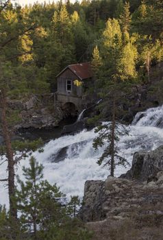 old wooden house near waterfall in norway near the jotunheimen national park at leira village