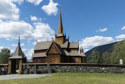 Lom stave church (Lom stavkyrkje) with graveyard foreground, Lom, Norway