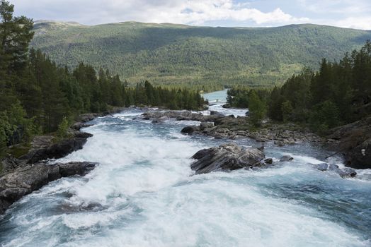 waterfall and rocks in norway near geiranger otta river