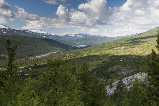 landscape with hills water forest and small houses in the area of bismmo in norway