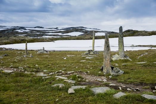 piles of stones as a monument on road 55 where man with horses died by freezing dead when crossing this moutains in 1862