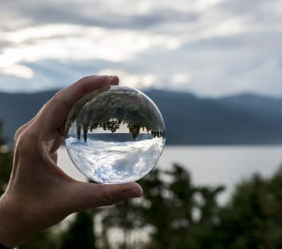 sognefjord with reflection of the fjord in glass sphere