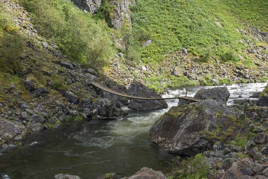 bridge at the walking track to the voringfossen waterfall in norway