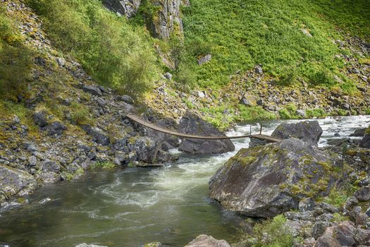 bridge at the walking track to the voringfossen waterfall in norway