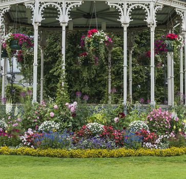 arbor with flowers and perennials and hanging plants in bergen norway