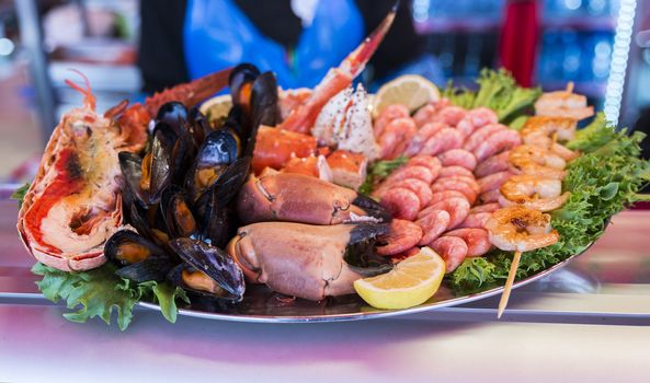 plate with Various seafood on the shelves of the fish market in Norway, Bergen
